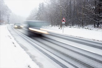 Two cars driving on snow-covered road