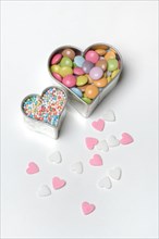 Chocolate lentils and love beads in heart-shaped cookie cutter