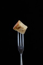 Bread cubes on fondue fork