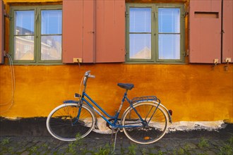 Bike leaning against the orange wall
