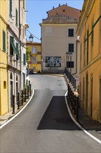 Narrow alley with pastel-coloured house facades