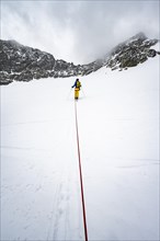 Ski tourers ascending the rope