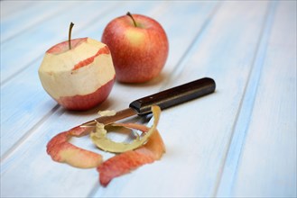 Peeled apple with peeling knife