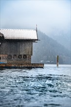 Boathouse with snow on the lake