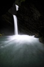 Waterfall in dark gorge