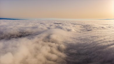 Aerial view over the sea of fog in the Central Plateau with Sahara dust in the air