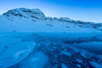 Ice structures in the black ice of the frozen Lago Bianco in the Swiss mountains