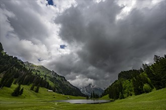 Groeppelensee with Altmanngipfel in the background under a threatening cloudy sky