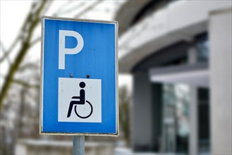 Close up of a blue disabled person parking permit sign on street