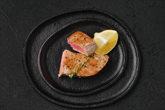 Top view of roasted tuna steak in a slate plate