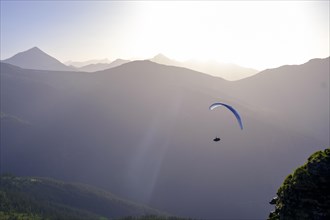 Paraglider at sunset