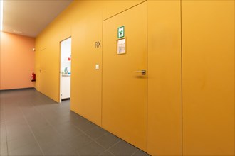 Corridor of a dental clinic with multiple boxes and the x-ray room