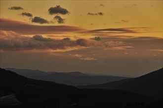 Vegetation of forests in the hills with clouds by sunset