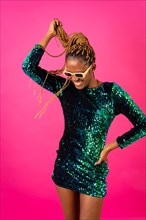 African young woman with party braids on a pink background