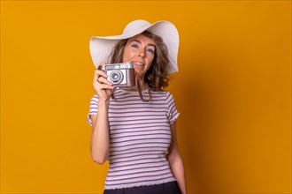 Caucasian girl in tourist concept on a yellow background