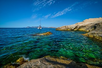 Yacht boat in Aegean sea at white rocks of Sarakiniko Beach