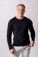 Attractive blond german model with black sweater on a white background