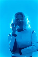 Young woman with futuristic suit and glasses with blue led lights