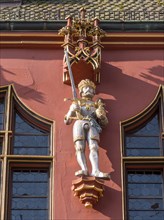 Statue on the facade of the Historic Red Department Store on Muensterplatz
