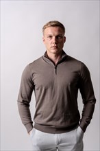 Blond caucasian man with brown sweater on a white background