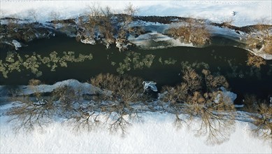 Drone shot of Fulda river with ice in winter