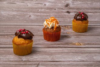 Assortment of chocolate and cream and carrot cupcakes on various backgrounds