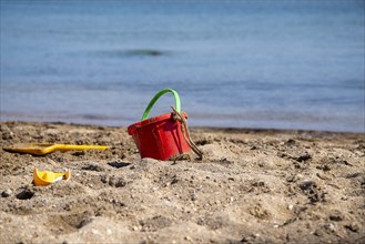 Sand toys on the beach with water surface in the background