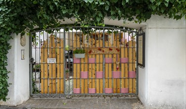 Decoratively designed entrance gate to a garden restaurant