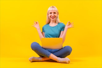 Smiling sitting with a laptop