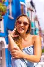 Portrait of attractive young blonde woman in sunglasses in a posed