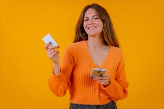 Woman looking at paying with card online on mobile phone