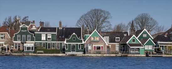 Panoramic photo of a typical colourful country house in Zaandijk on the river Zaan