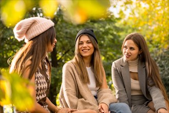 Women friends in a park in autumn carefree