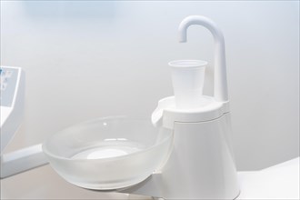 Plastic cup to rinse your mouth in the dental clinic with water