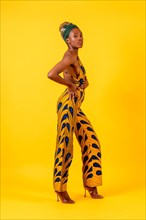 African young woman in the studio on a yellow background