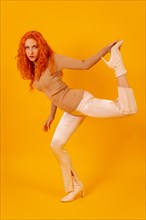 Red-haired woman on a yellow background