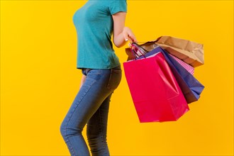 Unrecognizable person with colored shopping bags on discounts