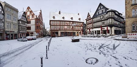 Panorama photo market place with half-timbered houses on it with snow