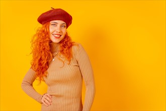 Red-haired woman in a red beret on a yellow background
