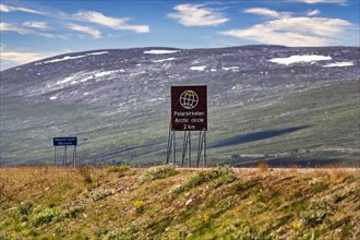 Sign in barren landscape shows distance to Arctic Circle Centre