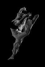 Young dancer in studio photo session with a black background