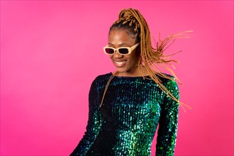 Black ethnic woman with braids party dancing on pink background