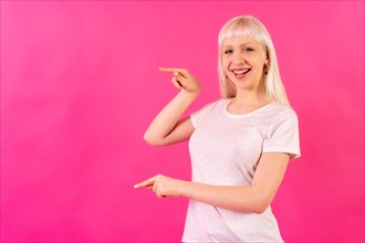 Blonde caucasian girl on pink background studio