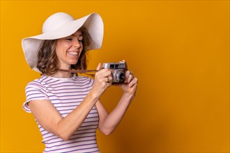 Caucasian girl in tourist concept with hat and photo camera enjoying vacation