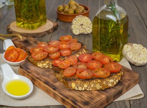 Toast bread with cherry tomato and olive oil with rosemary