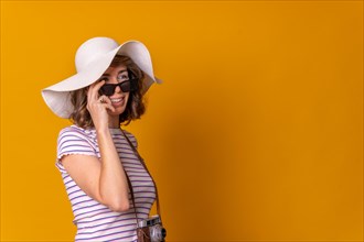Caucasian girl in tourist concept with a hat and sunglasses enjoying summer vacation