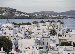 View over the white Cycladic houses of Mykonos town with windmills