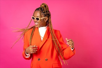 African young woman with braids on a pink background