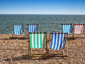 Colourful deckchairs by the sea