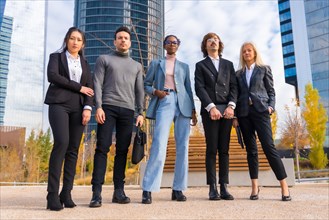 Corporate portrait of group of multi-ethnic businessmen and businesswomen outside offices